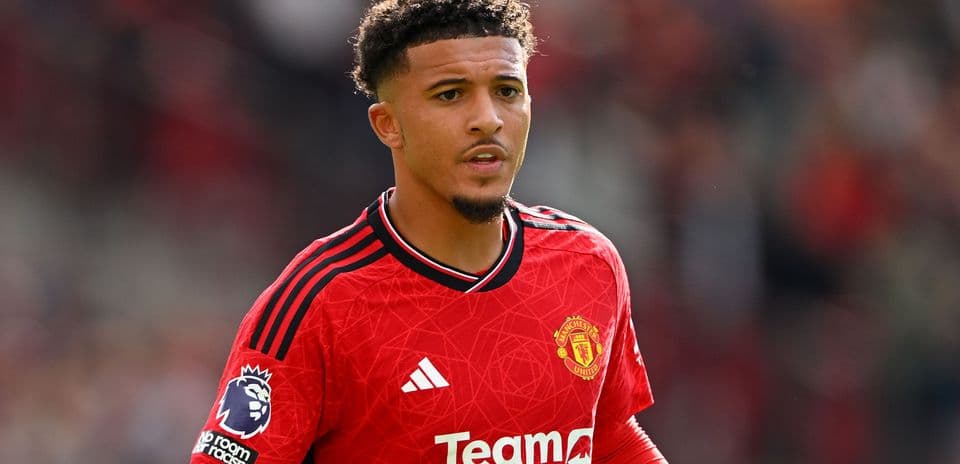 Player in Manchester United red kit on field