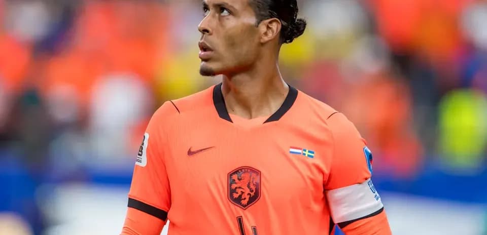 Player in orange jersey looking upwards during match