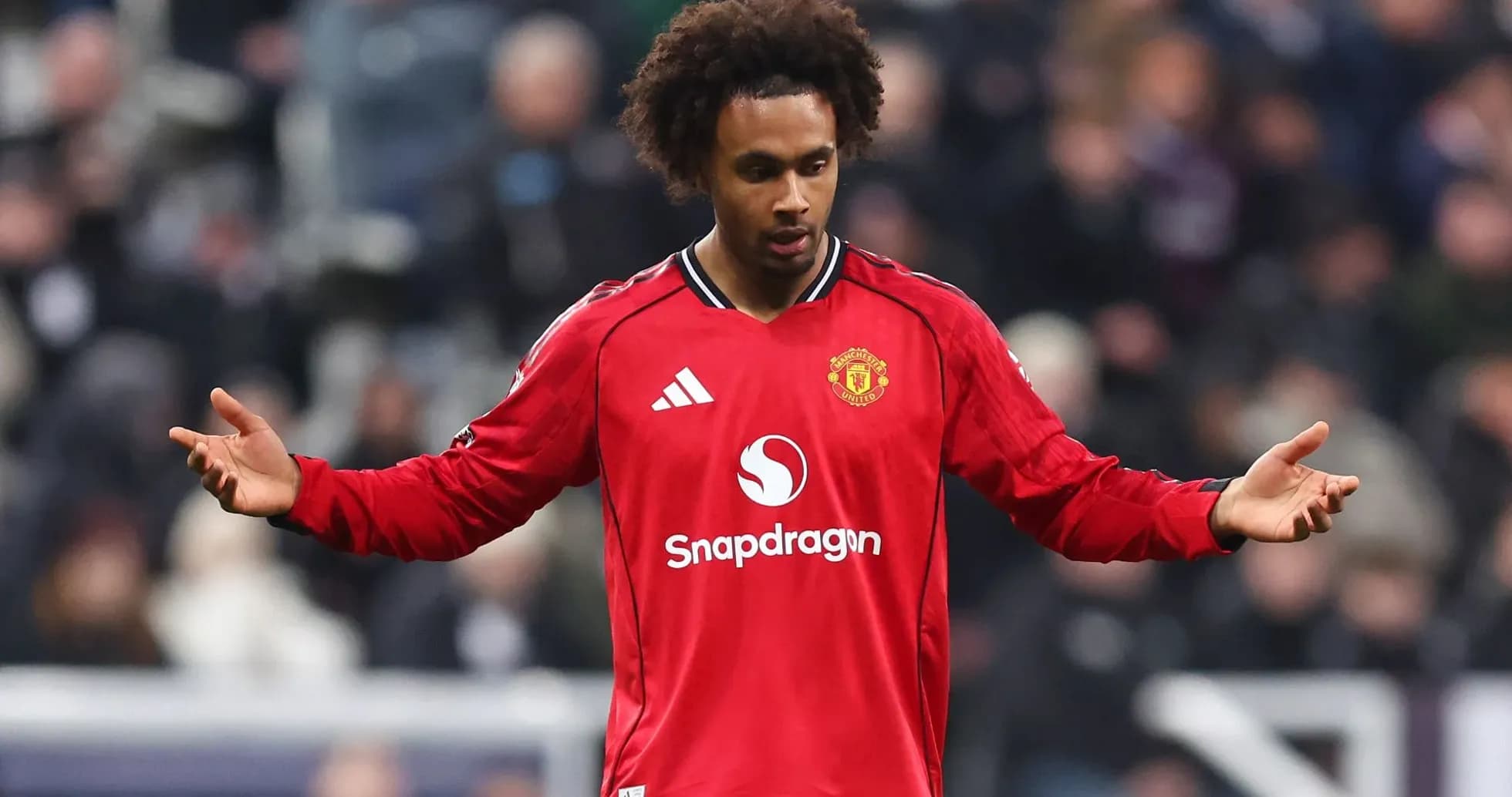 Player in red Manchester United jersey gesturing during match