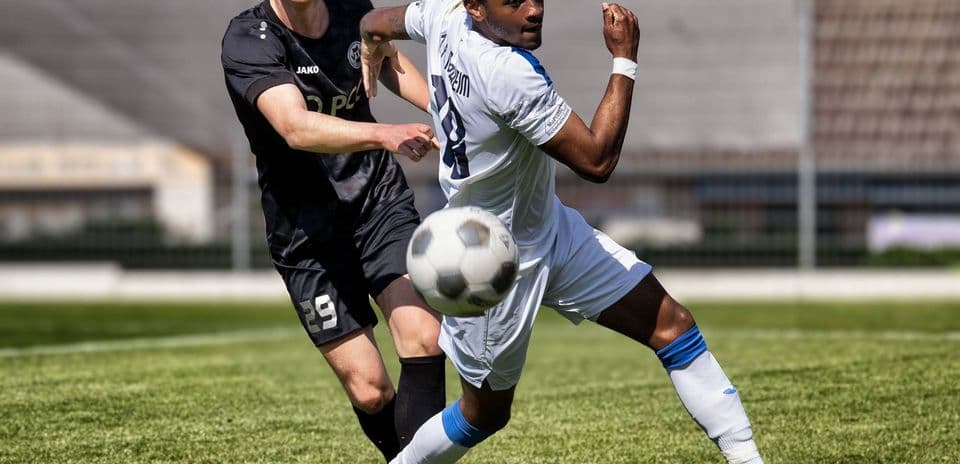 Player kicking ball during Monheim vs Germania Ratingen match