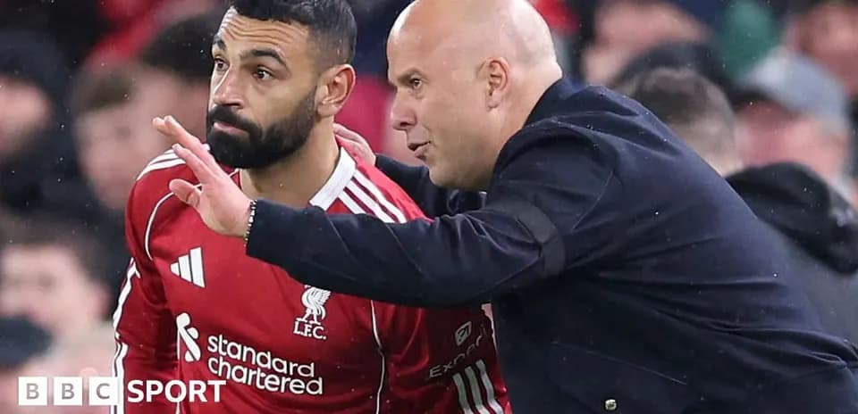 Player receiving instructions from coach on sidelines