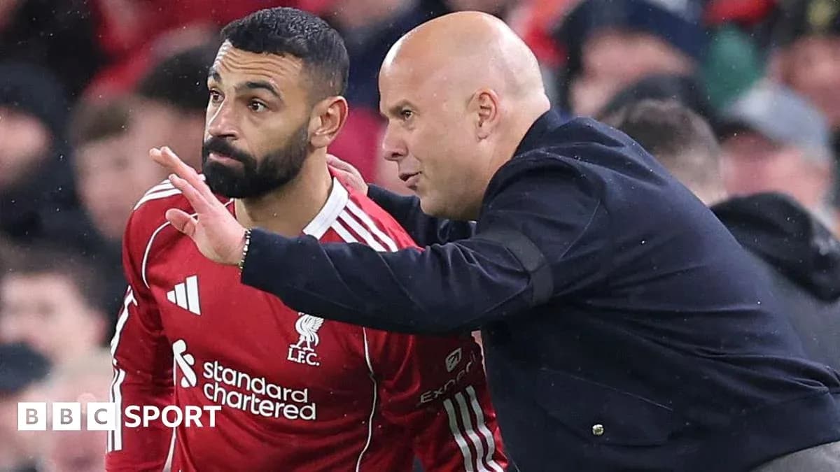 Player receiving instructions from coach on sidelines