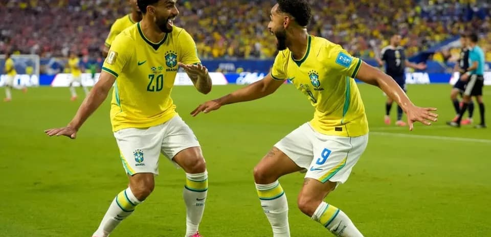 Two Brazilian players celebrating a goal on the field