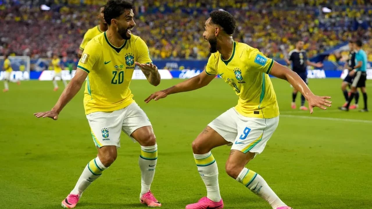 Two Brazilian players celebrating a goal on the field