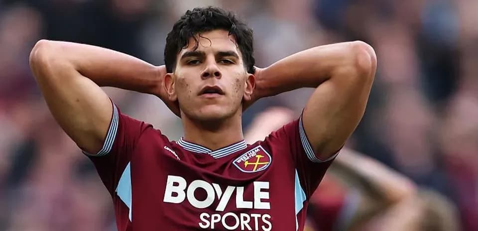 Player in maroon jersey with hands on head