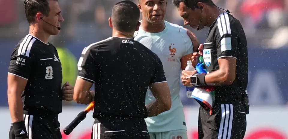 Kylian Mbappé talking to referees during match