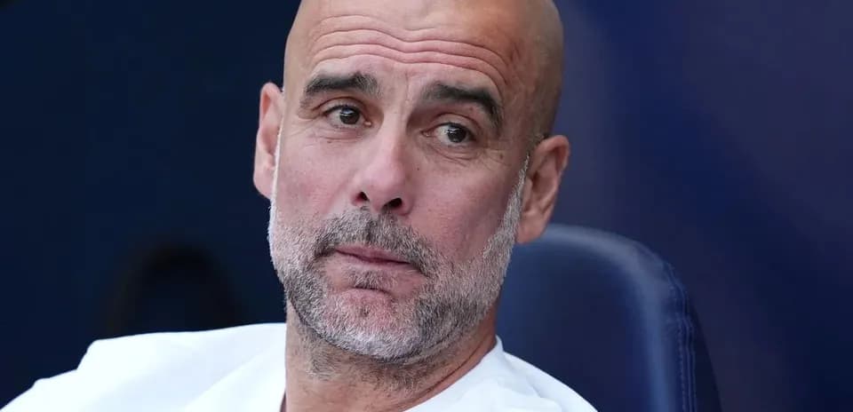 Manager sitting on the bench during a match