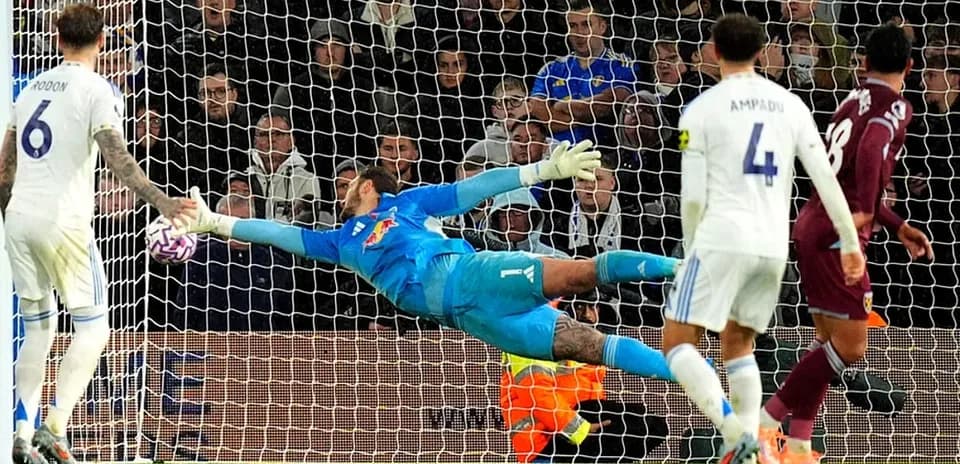 Goalkeeper saves penalty during match action