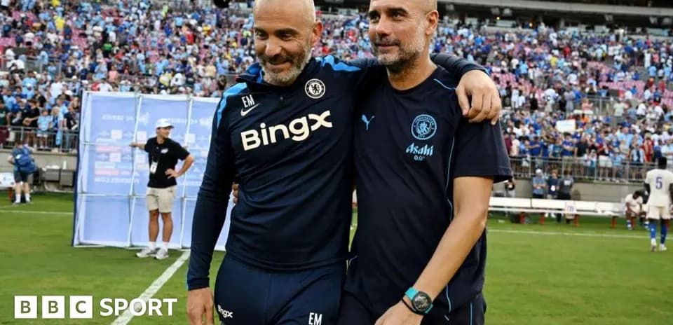 Two coaches embracing on the field after match