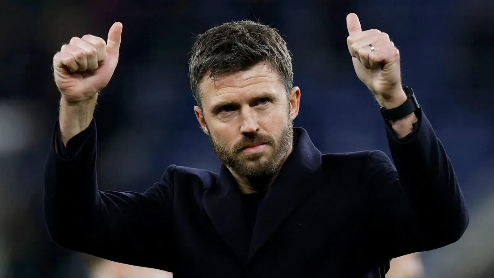 Coach celebrating with thumbs up gesture