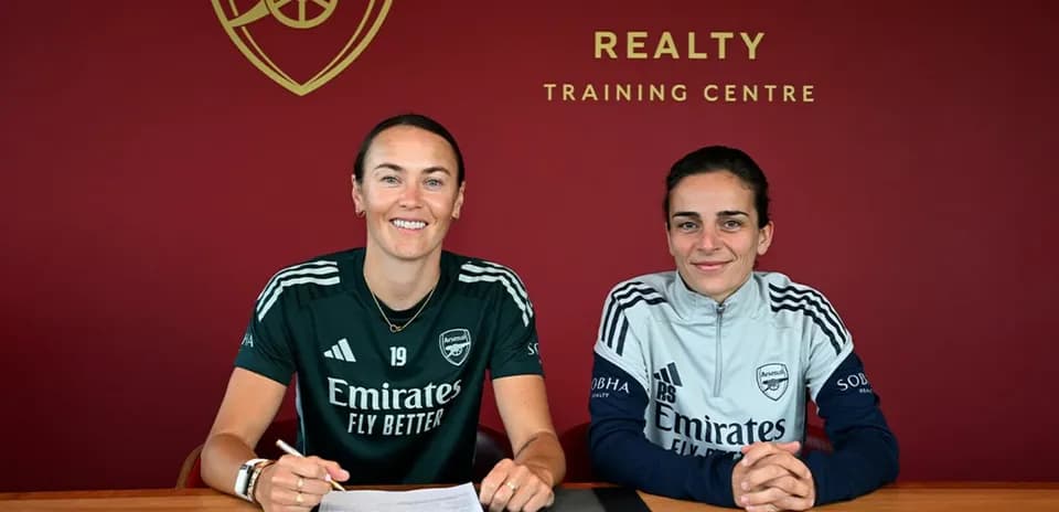 Two players signing contracts at Arsenal training centre