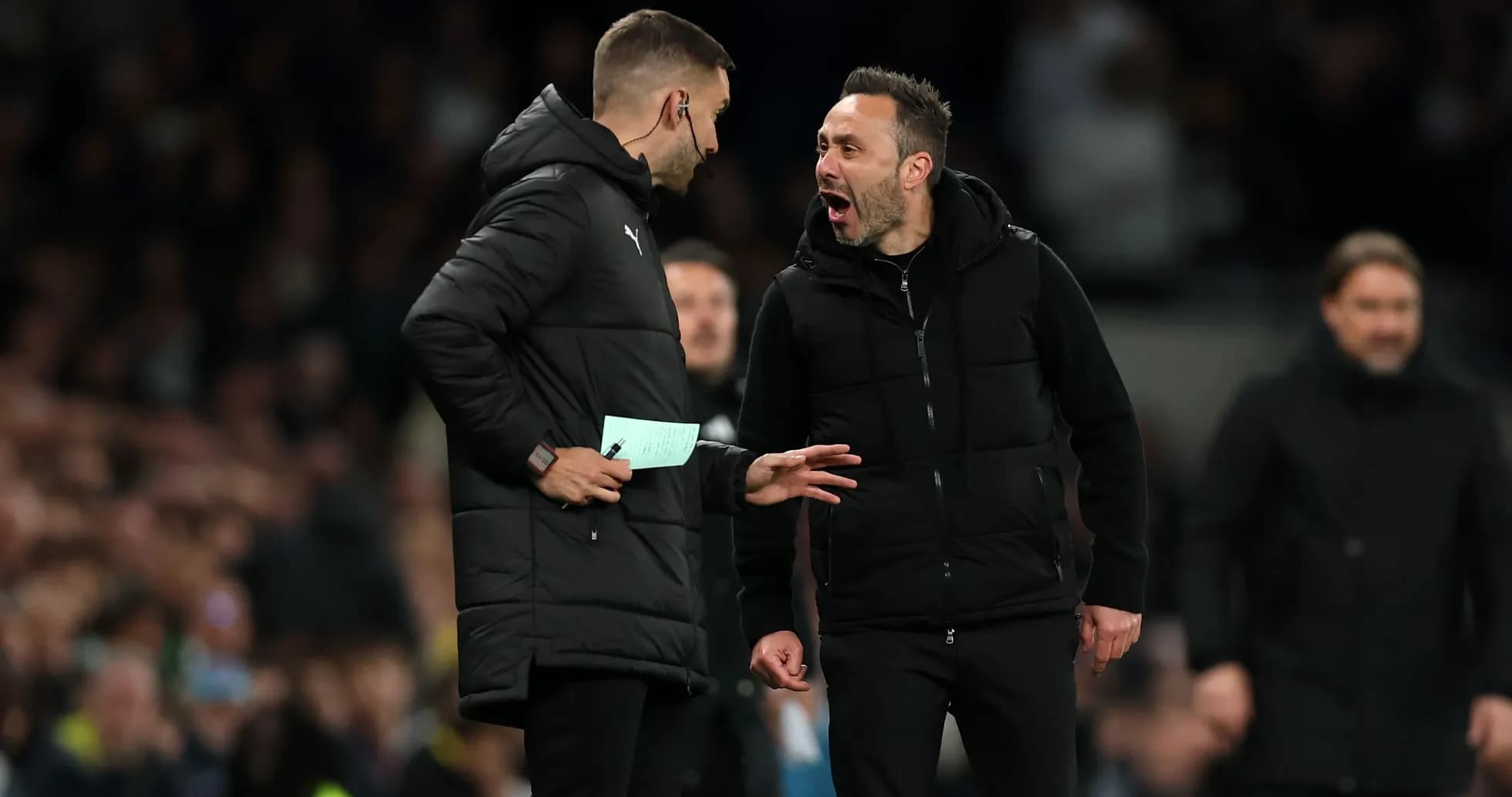 Coaches discussing strategies during a match