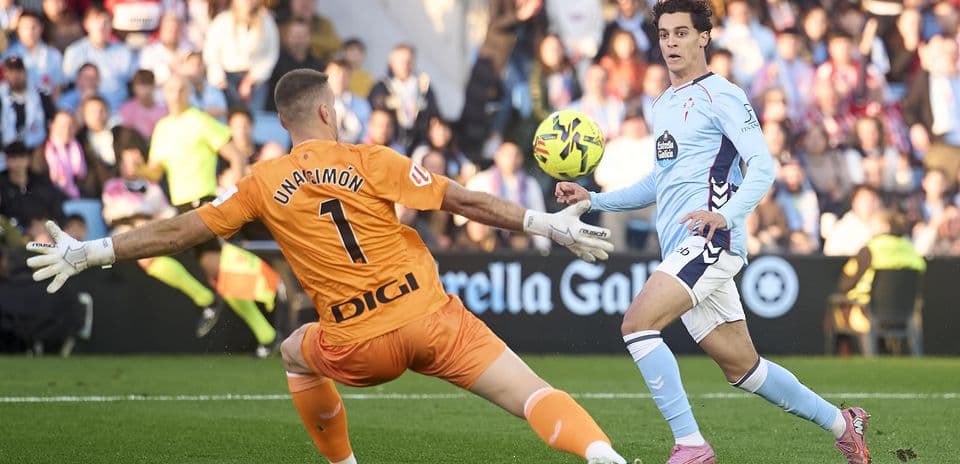 Goalkeeper attempting to save a shot during match