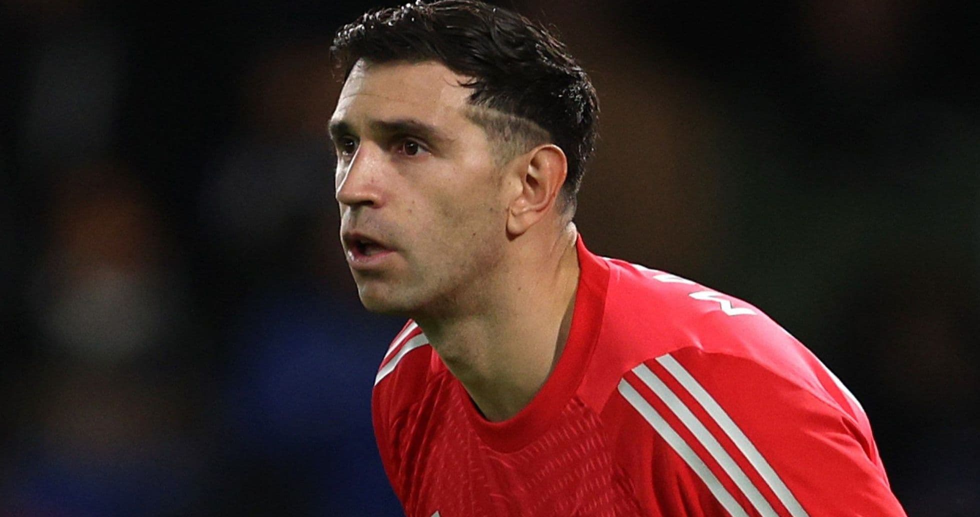 Goalkeeper in red kit during match action