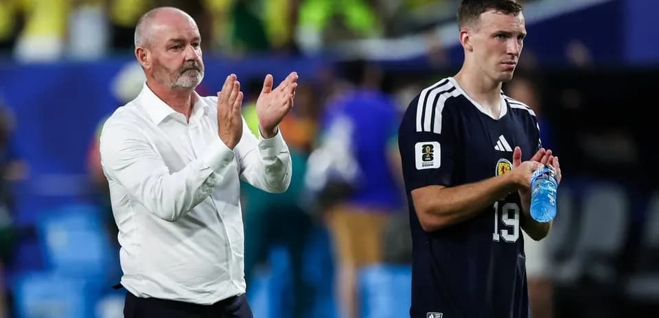 Coach and player applauding after the match