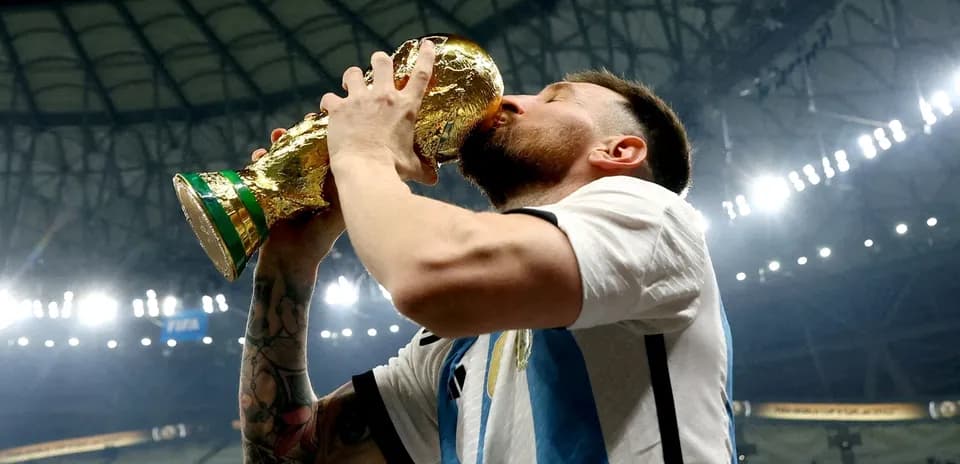 Player celebrating by kissing the World Cup trophy