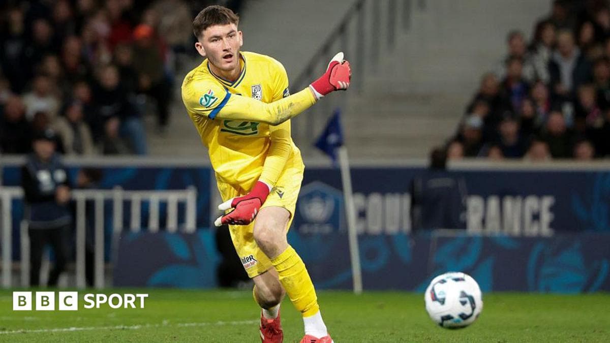 Goalkeeper in yellow kit making a throw
