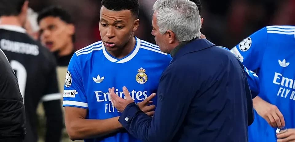 Manager talking to player during match on field