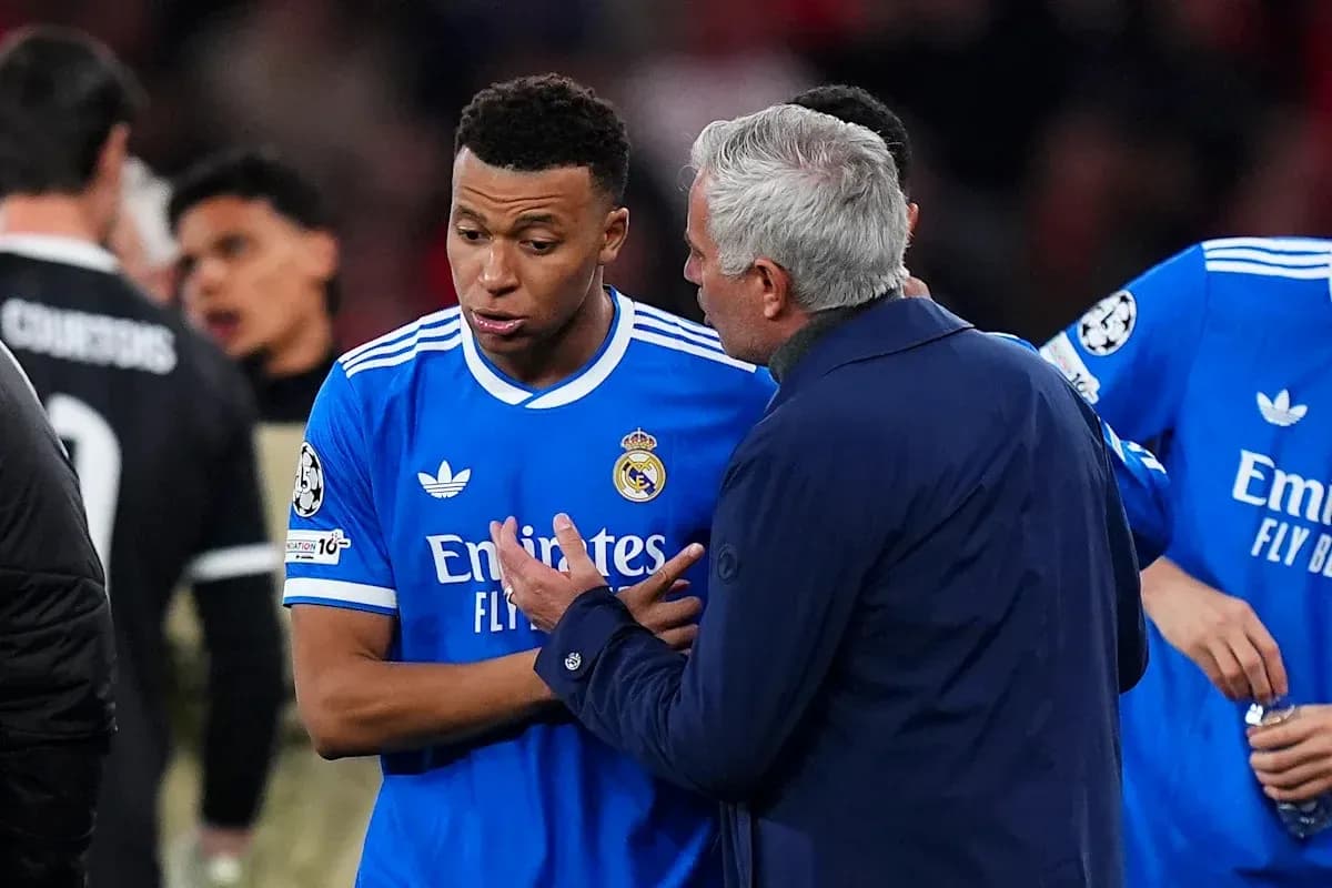 Manager talking to player during match on field