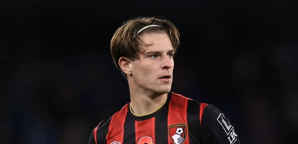 Bournemouth player in black and red jersey on field
