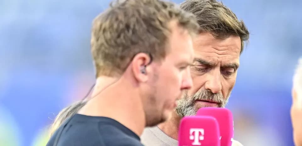 Two men discussing during a sports broadcast interview