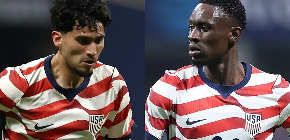 Two players in USA soccer jerseys during match