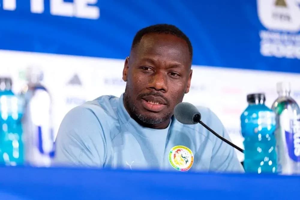 Manager speaking at press conference with water bottles