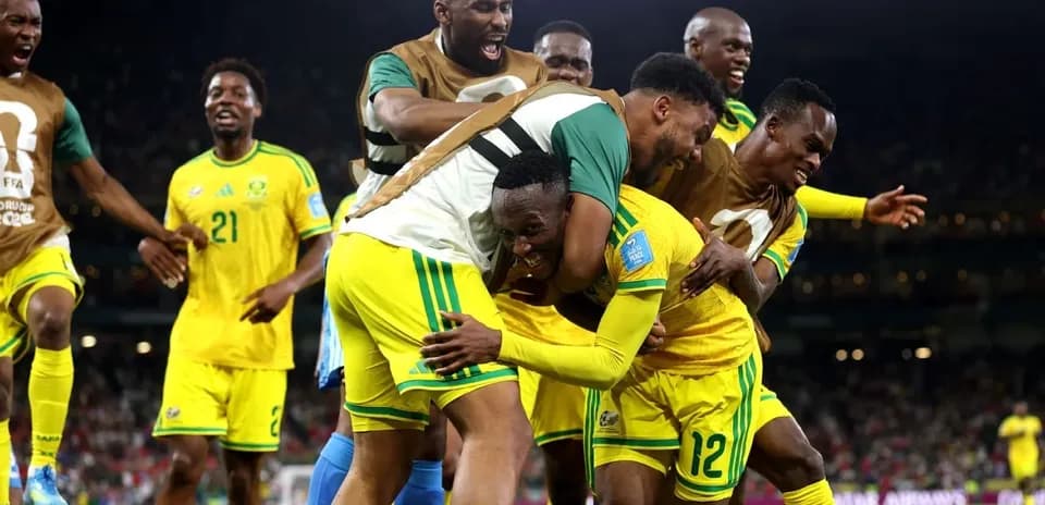 Players celebrating a goal in a match