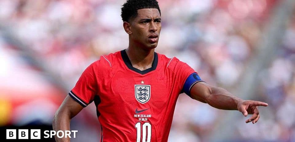 Player in red England jersey pointing during match