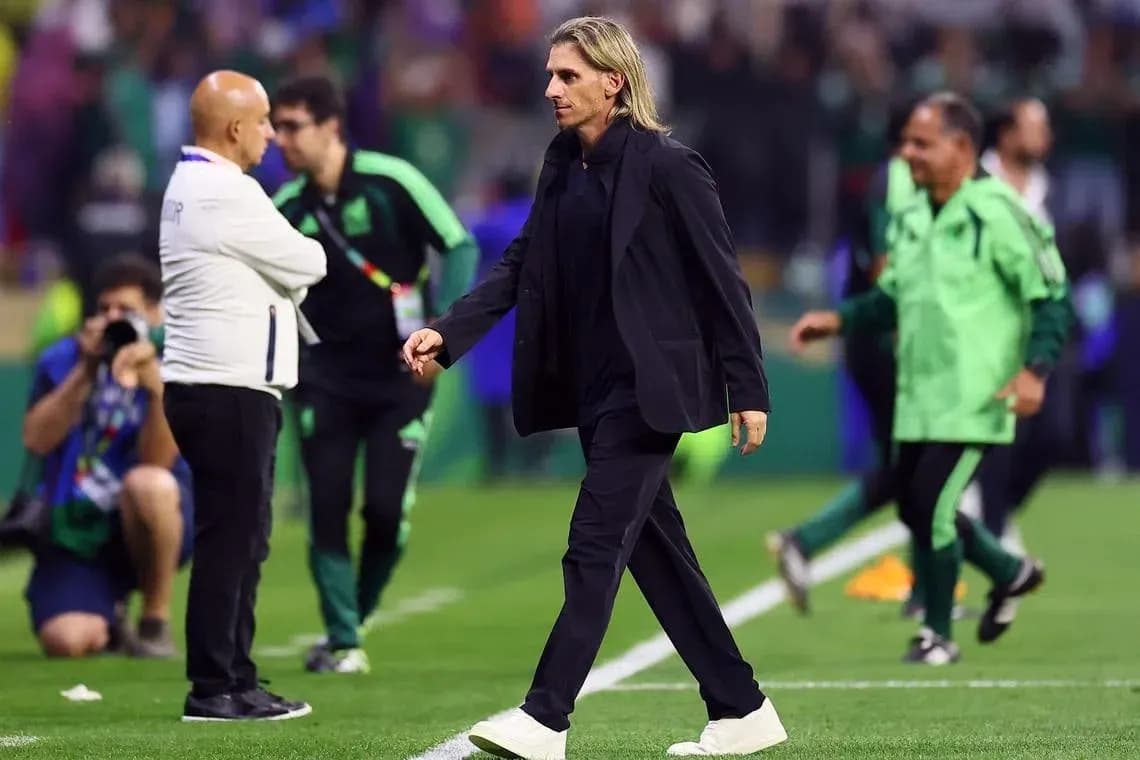 Coach walking on the pitch during match