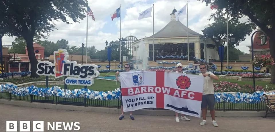 Fans holding Barrow AFC flag at Six Flags