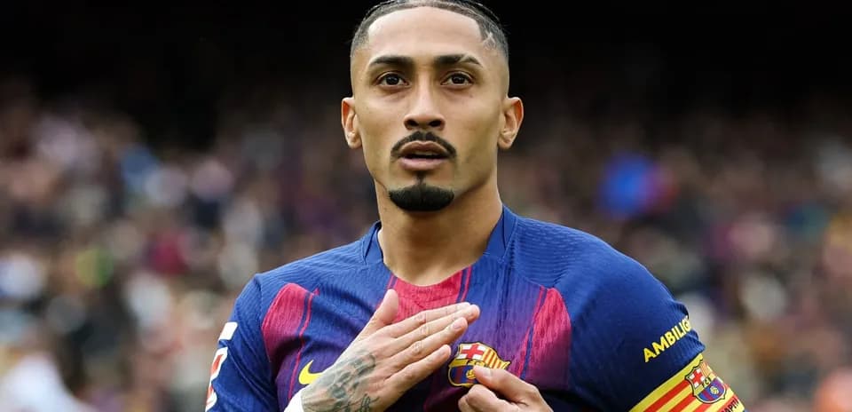 Player touching club badge on jersey during match
