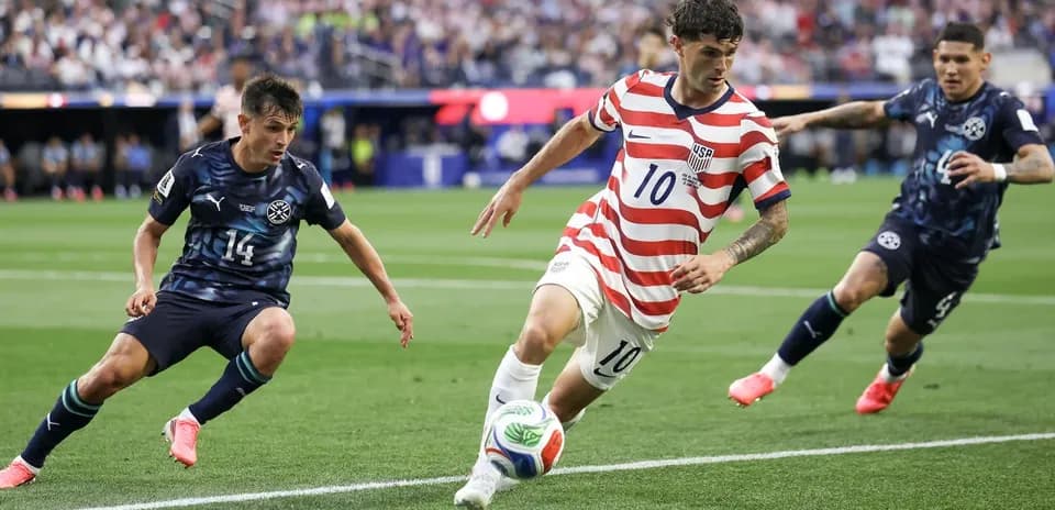 Player in striped jersey dribbling past defenders on field