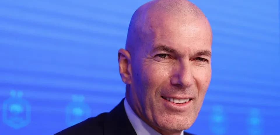 Man smiling at a press conference backdrop