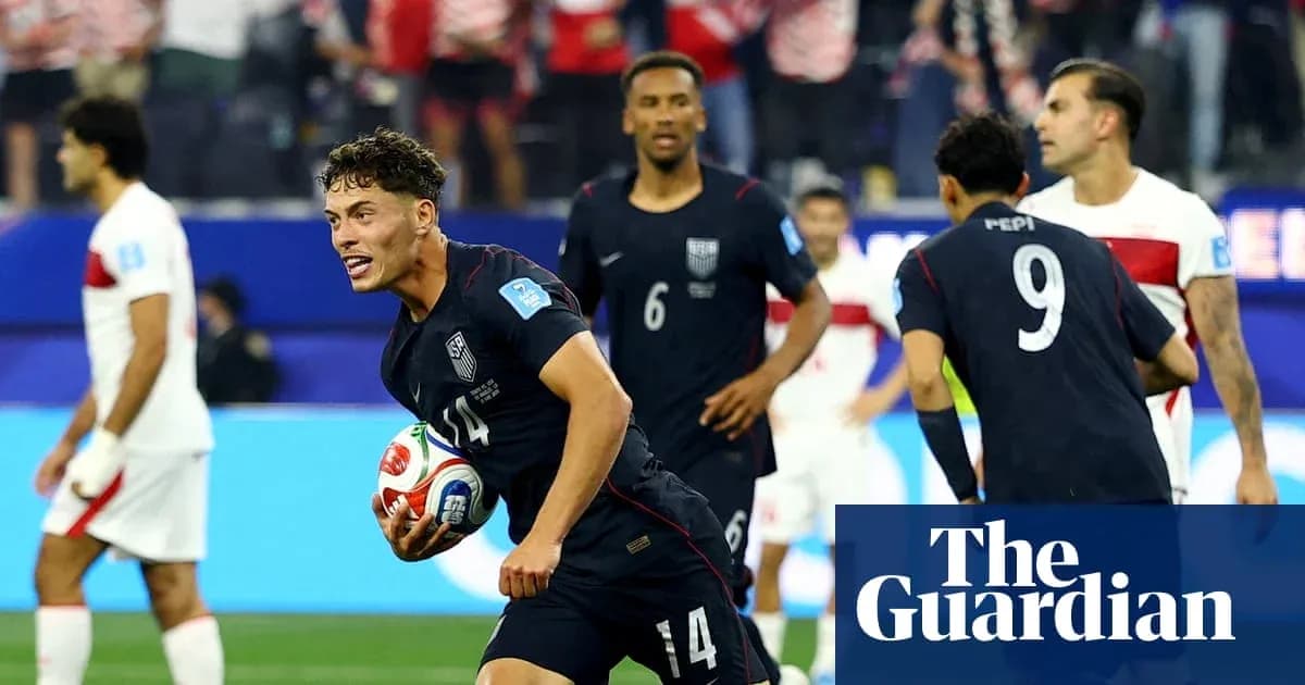 US player celebrating with soccer ball after scoring