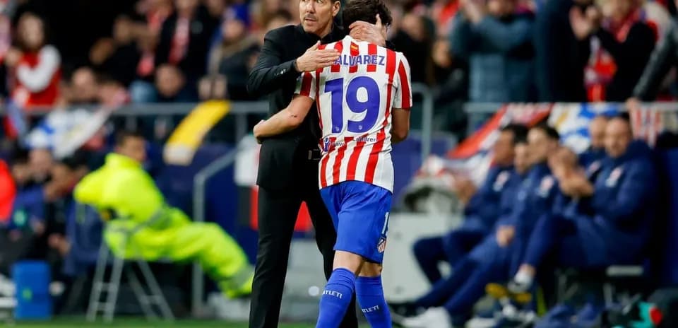 Coach embracing player during match at stadium