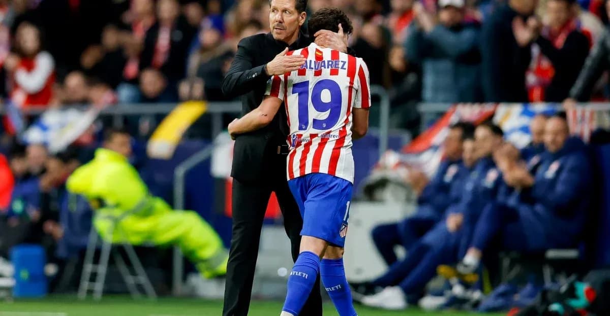 Coach embracing player during match at stadium