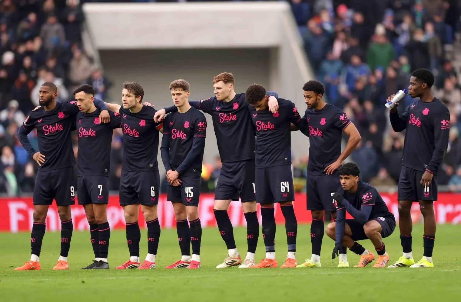 Everton players standing together before the match