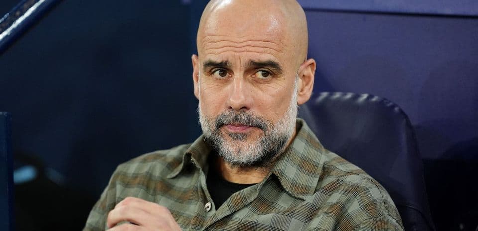 Manager seated on bench during match preparation