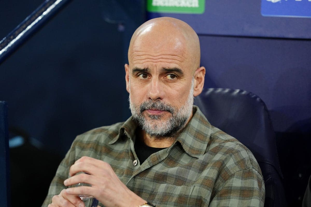 Manager seated on bench during match preparation