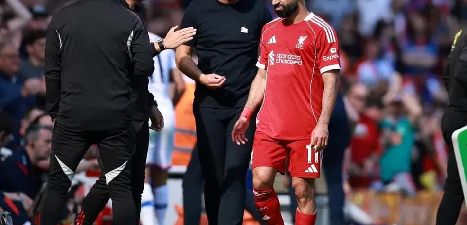 Mohamed Salah leaving the pitch with staff during match