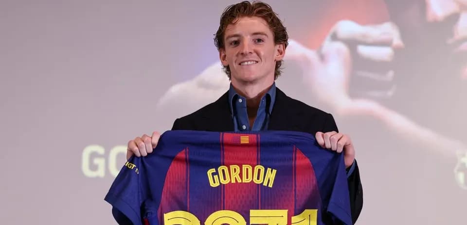 Player holding Barcelona jersey at presentation event