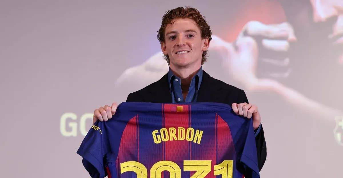 Player holding Barcelona jersey at presentation event