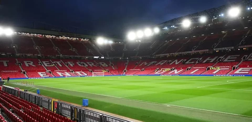 Empty stadium with Manchester United signage and pitch