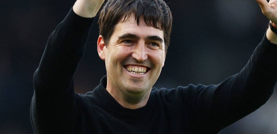 Coach waving to fans after a match