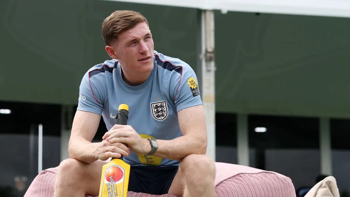 Player sitting with a cricket bat during training