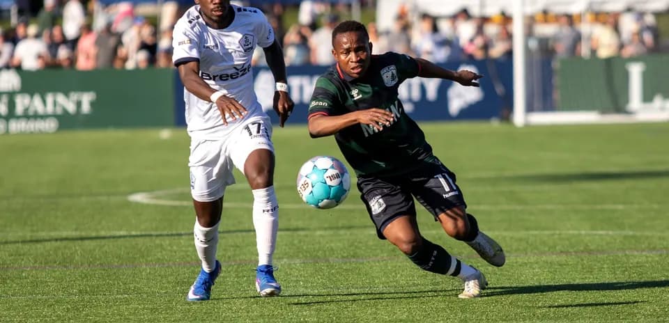 Two players competing for the ball during match