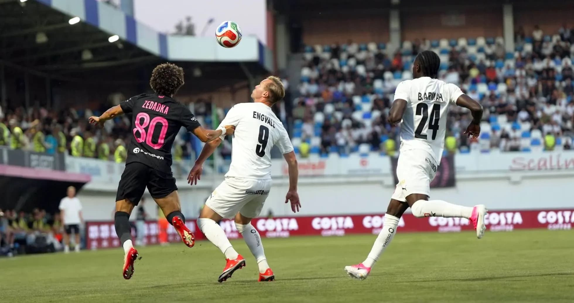 Players competing for the ball during KuPS match