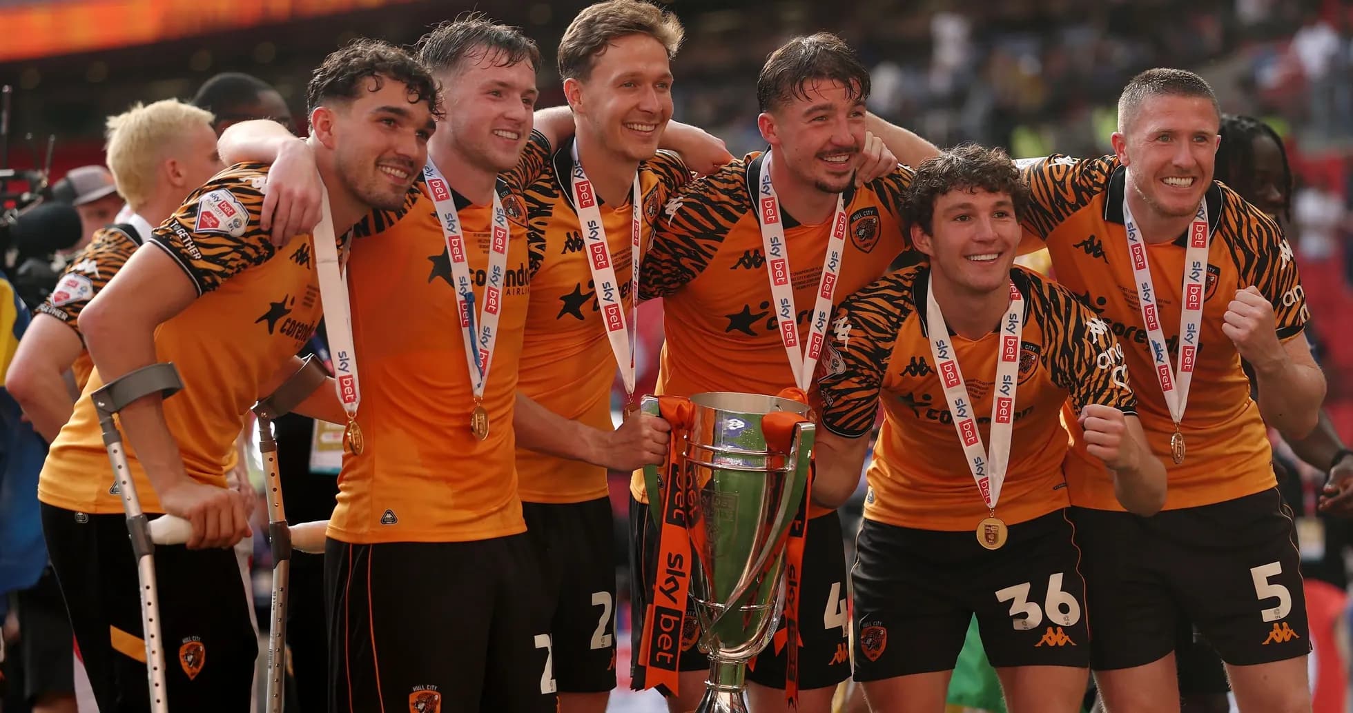 Players celebrating with trophy after match victory