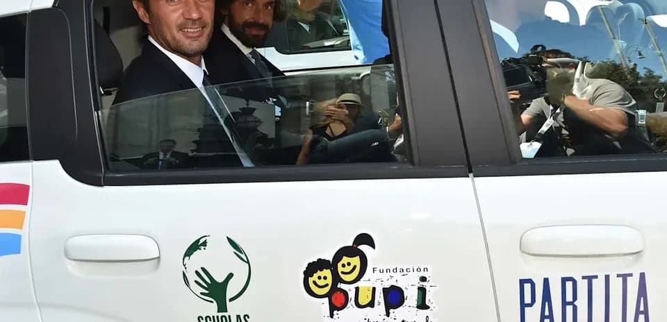 Two men in suits inside a car
